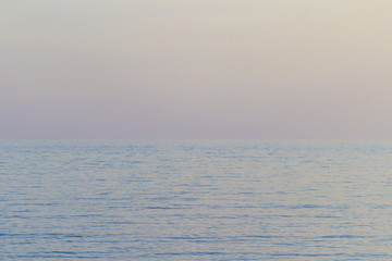 The sea at sunset, the sky in pastel colors.