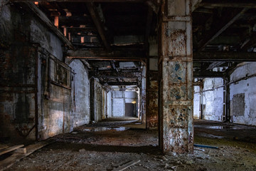 Fototapeta na wymiar Dark and creepy interior of abandoned factory