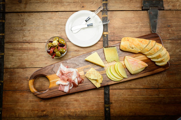 Delicious Meat and Cheese Board with Bread, Apple and Olives