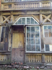 Fototapeta na wymiar Fragment of an old beautiful dilapidated wooden house