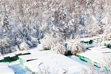 above view of snow-covered garages and snowy park
