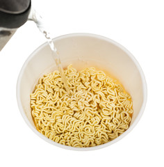 pouring water into box with dried instant noodles