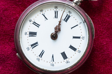 retro pocket watch on red velvet close up