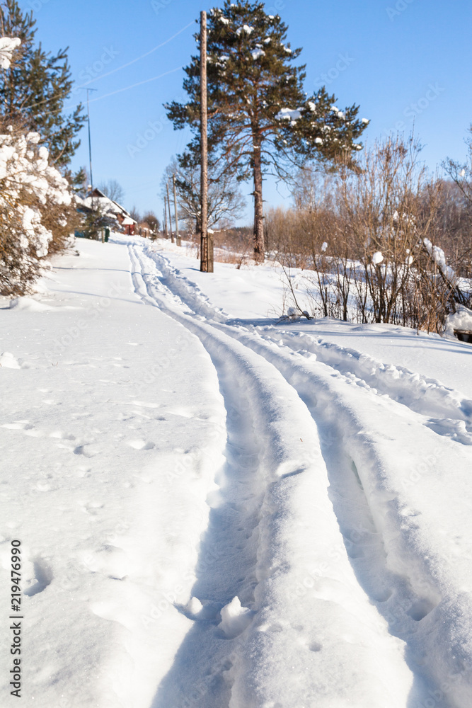 Sticker ski track at outskirt of russian village in winter