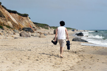 Young Man Walking on Beach on Martha's Vineyard Island in Massachusetts