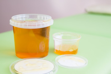 big and small jar sugar paste or wax honey for hair removing - depilation and beauty concept