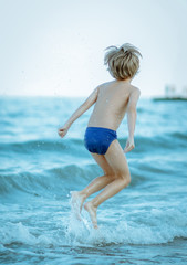 jumping boy on the waves