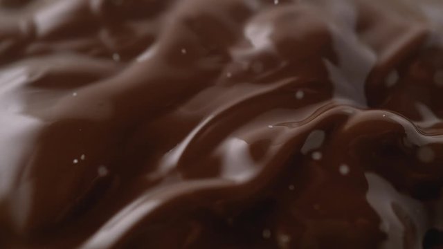 Sprinkling salt or sugar on chocolate. Shot with high speed camera, phantom flex 4K. Slow Motion.