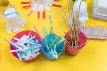 stationery materials for activities with children. Straws, felt-tip pens, scissors, sticks in colored boxes for the construction of games and experiments. materials for activities with school kids