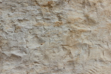 Texture of an old wall. Surface of an ancient temple in Prague. Background of stone for the designer. Pattern in brown tones