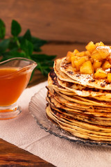 Pancakes with apple  jam and honey, wooden background, vertical frame.