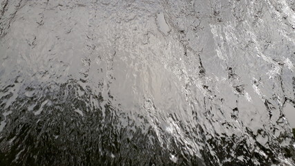 Wide stream of water falling in a semi-translucent park