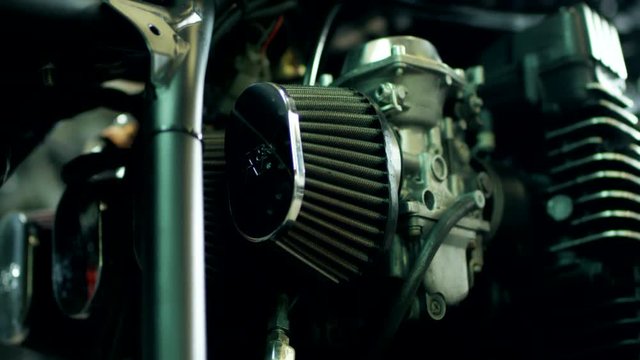 Vintage motorbike detail. Close up of motorcycle carburetor and air filter. Vintage chopper engine. Automotive shop advertising. Motorbike spare parts. Chopper motorcycle background