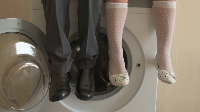 Back to school. Portrait of happy children with blue eyes and blond hair in school uniform. Boy and a preschool girl sitting on washing machine at home in bathroom. Shallow focus