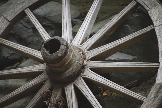 Close up image of a vintage wooden wagon wheel