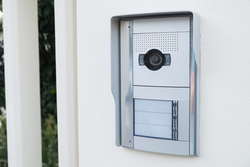 white intercom with a camera on the door of a private house