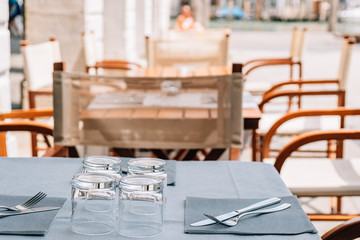 Serving tables of the summer cafe-restaurant on the city street.