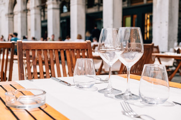 Serving tables of the summer cafe-restaurant on the city street.