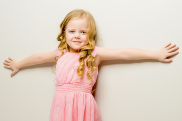 A nice little girl leaned her back against the wall.