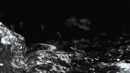 Boiling water on black background. Shot with high speed camera, phantom flex 4K. Slow Motion.