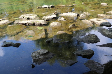 Naklejka na ściany i meble Natural stepping-stone at winter public park stream 