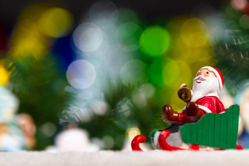 Santa man sitting on sleigh and lighting background