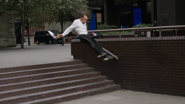 Young parkour athlete running and jumping in the city, in slow motion 