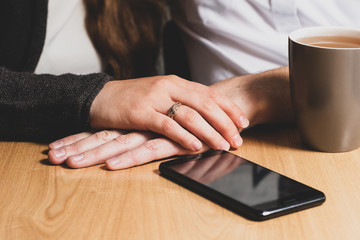 The female hand caresses a male hand.