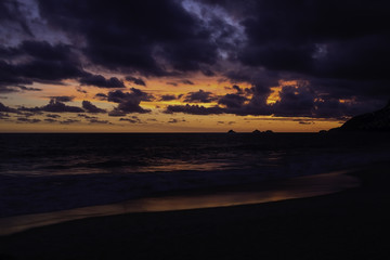 Fototapeta na wymiar Sunset light reflected in the ocean on the beach in Rio de Janeiro Brazil