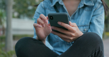 Woman use of mobile phone with blur background