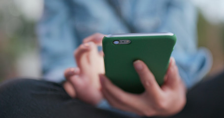 Woman use of mobile phone with blur background
