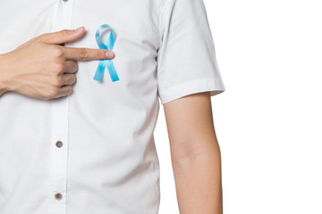 Men's healthcare concept - male hand pointing to light blue ribbon for prostate cancer at left...
