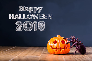 Happy Halloween 2018 message with pumpkin and spider on black background