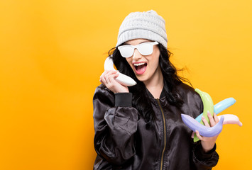 Fashionable woman in quirky trend concept with painted fruit on a solid background