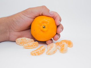 man holding tangerine isolated on white background