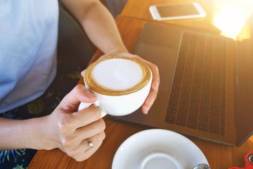 hands holding a cup of tea