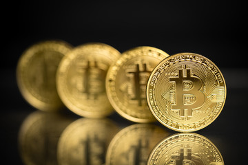 Row of bitcoins in physical form with black background