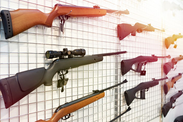 Air guns on stand in shop
