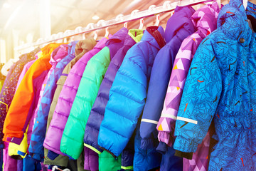 Winter children sports jacket on hanger in store - obrazy, fototapety, plakaty