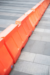 Red plastic barriers blocking the road.