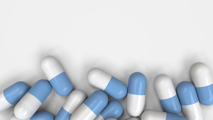 Pile of white and blue medicine capsules