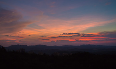 Sunset with silhouette of big mountain in summer