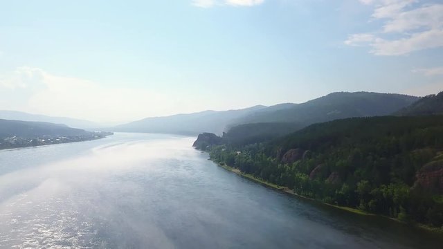 Beautiful aerial footage of the river Yenisei with mountains on the background
