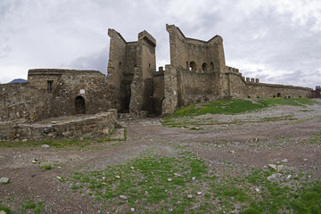 Genoese fortress in Sudak, Crimea. The wall and the tower at the entrance to the fortress.