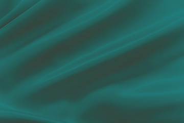 Smooth elegant shiny green silk or satin luxury cloth texture can use as abstract holidays background. Luxurious Christmas background or New Year background design.