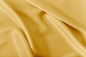 Smooth elegant shiny gold silk or satin luxury cloth texture can use as abstract holidays...