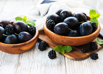 Bowls with fresh plums