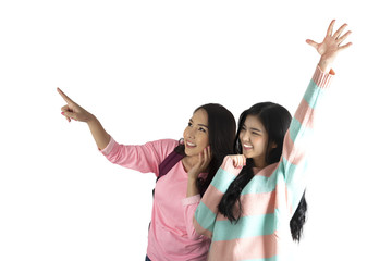 Two cute asian girls in happy movement on white background.