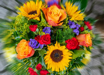 a bouquet of orange roses sunflower cloves and green leaves