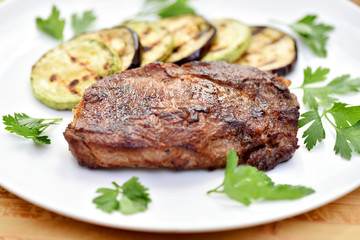 Meat cooked on a grill. Fried beef steak. Healthy food. Restaurant main course.